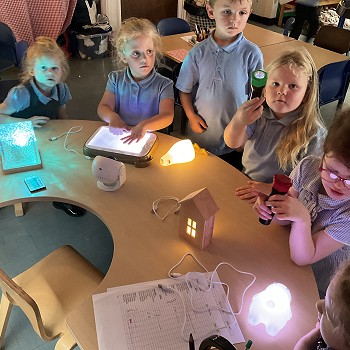 students playing with light up toys