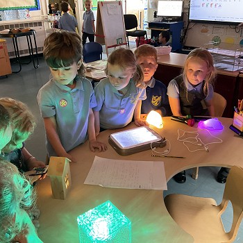 students using a remote to control the colour of the lights
